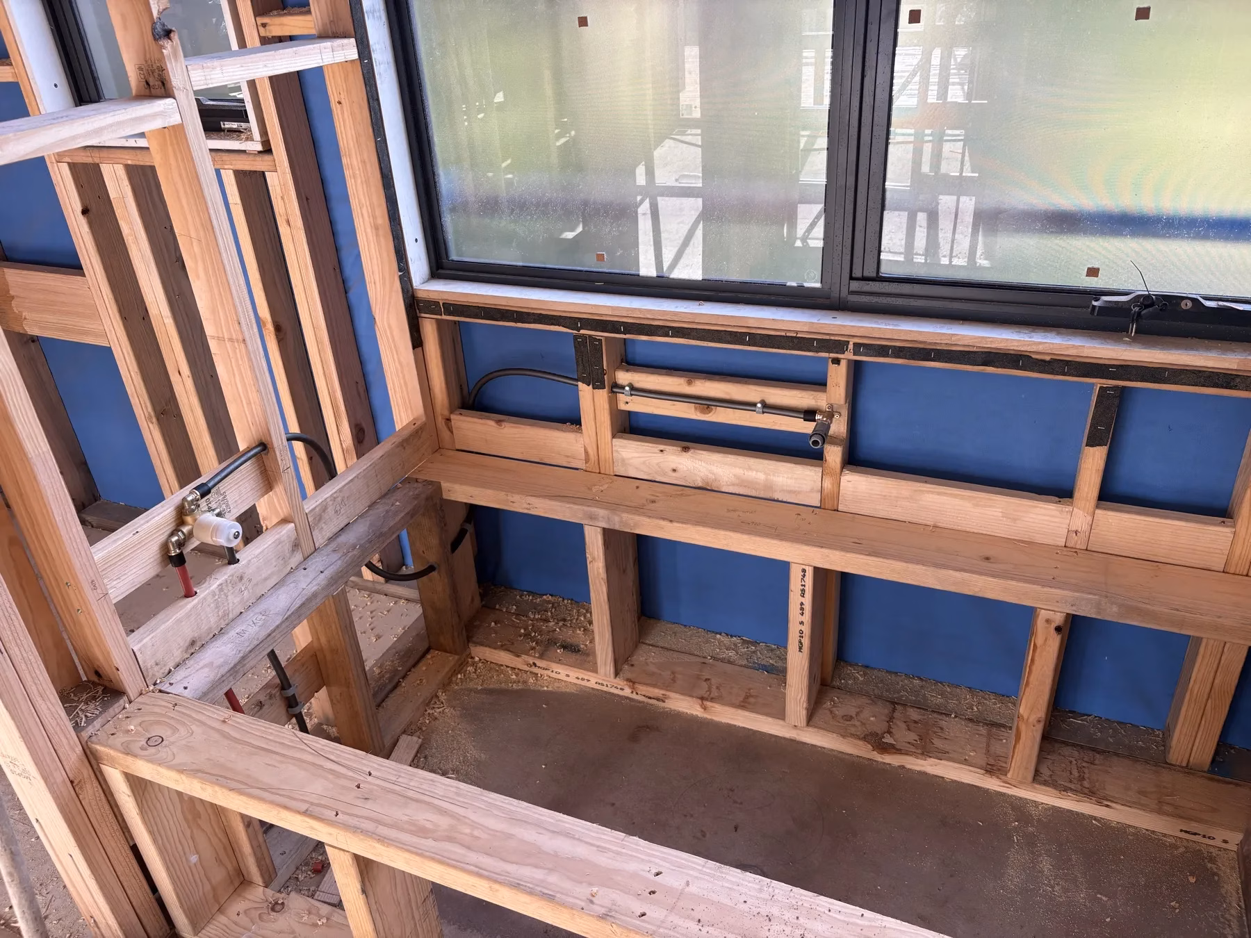 Water and waste pipework installed in an open timber wall